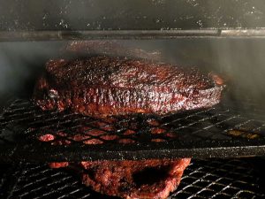 Beef Briskets in Smoker | Love and Smoke Barbecue