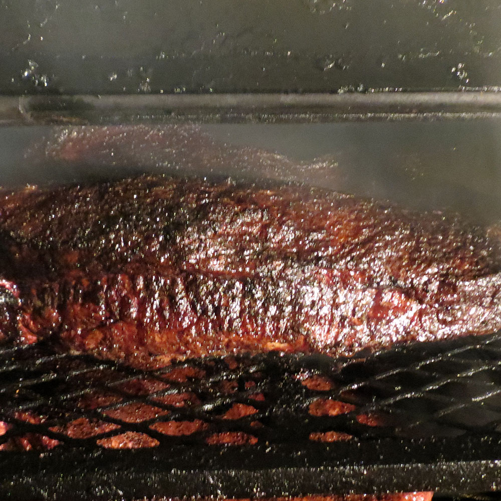 Beef Briskets in Smoker | Love and Smoke Barbecue